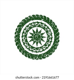 Green sun icon inside rubber grunge texture seal. 