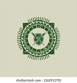 Green swords crossed with shield icon inside distress rubber seal