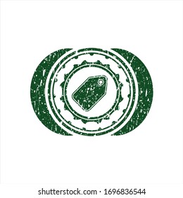 Green tag icon inside distressed rubber stamp with grunge texture