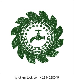 Green tap icon inside distressed rubber grunge stamp