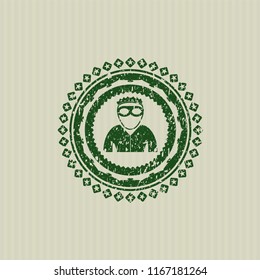 Green thief icon inside distressed rubber texture
