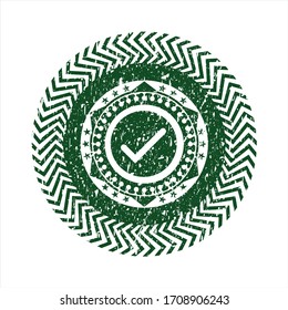 Green tick icon inside distressed with rubber seal texture. 