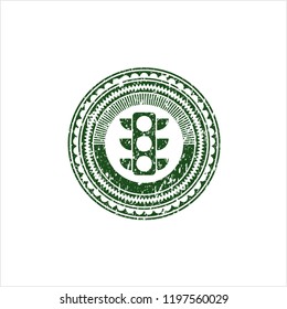 Green traffic light icon inside distressed rubber grunge texture stamp