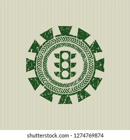 Green traffic light icon inside distressed grunge stamp