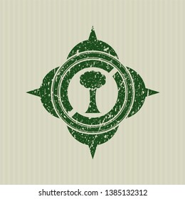 Green tree icon inside distress rubber grunge seal
