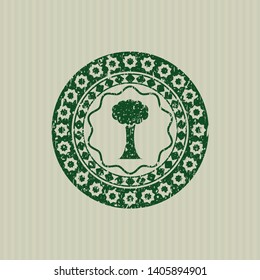 Green tree icon inside distress rubber grunge texture seal