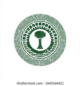 Green tree icon inside distress rubber grunge texture stamp