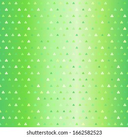 Green trefoil pattern. Seamless vector background - shamrocks of different size on glowing backdrop