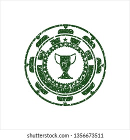 Green trophy icon inside distress rubber stamp with grunge texture
