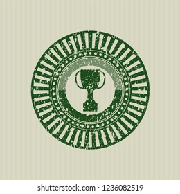 Green trophy icon inside rubber grunge seal