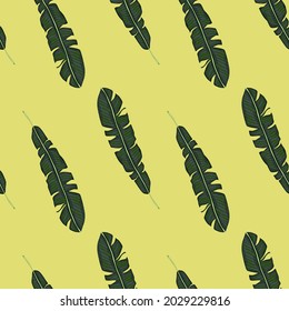 Green tropic leaf silhouettes seamless nature pattern. Pale yellow background. Exotic foliage print. Flat vector print for textile, fabric, giftwrap, wallpapers. Endless illustration.