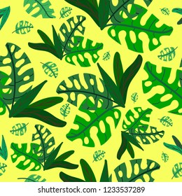 green tropical plants on a yellow color