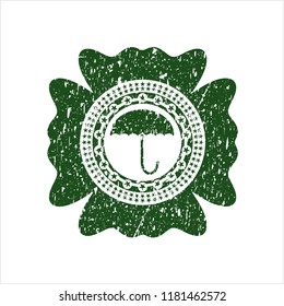 Green umbrella icon inside rubber seal