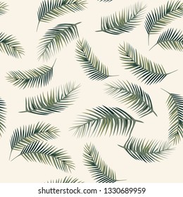 Green vector palm leaves. Seamless design pattern on the beige background