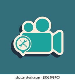 Green Video camera with screwdriver and wrench icon isolated on blue background. Adjusting, service, setting, maintenance, repair, fixing. Long shadow style. Vector Illustration