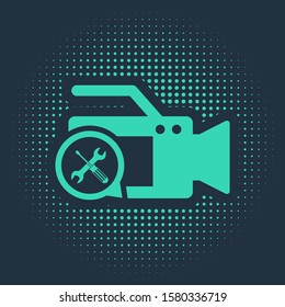 Green Video camera with screwdriver and wrench icon isolated on blue background. Adjusting, service, setting, maintenance, repair, fixing. Abstract circle random dots. Vector Illustration