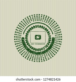 Green video player icon inside distressed rubber grunge texture stamp