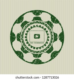 Green video player icon inside distress grunge stamp