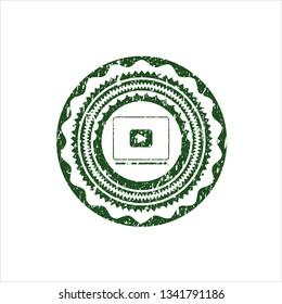 Green video player icon inside distressed rubber grunge stamp