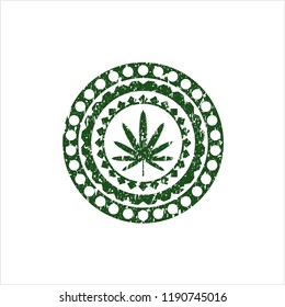 Green weed leaf icon inside distressed rubber grunge seal