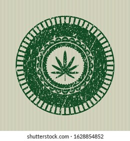 Green weed leaf icon inside distress rubber stamp