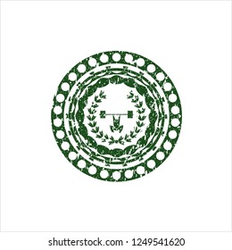 Green weightlifting inside of crown icon inside rubber seal with grunge texture