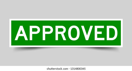 Green And White Sticker With Word Approved On Gray Background