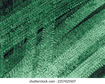 Green and white vector grunge background with texture of tire tracks on snow. UHD 4K wallpaper. For screen, desktop, website design, overlay, stencil, background, stylization, design and polygraph