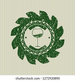 Green wine cup icon inside distress rubber stamp