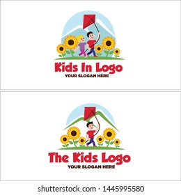Green yellow red logo design kids girl and boy playing kites in the sunflower garden suitable for outdoor playground label resort