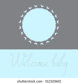 Greeting card with blue colored round space for photo decorated with blue colored prams on grey background and grey colored calligraphic lettering Welcome baby isolated on blue background