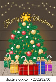 Greeting card with Christmas tree with star and balls, lights, gift boxes and licorice candy on wooden background.