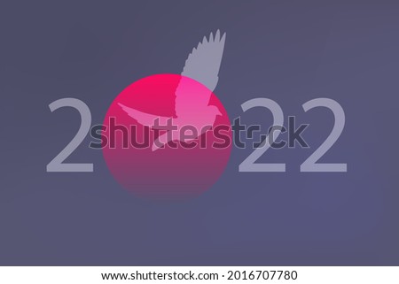 Greeting card concept for 2022, on the theme of peace and freedom with a dove that flies in front of a sunset.