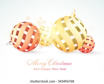 Greeting card design with glossy creative Xmas Balls on snowflakes decorated background for Merry Christmas and Happy New Year celebration.