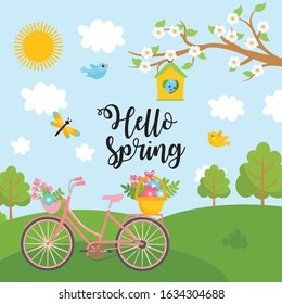 Greeting card design with spring landscape. "The spring time" message and place for your text. Sunny day with blossom tree, blue sky, green meadow and bike.