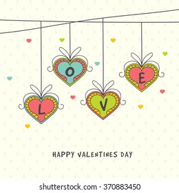 Greeting card design with stylish text Love on colorful hanging hearts for Happy Valentine's Day celebration.