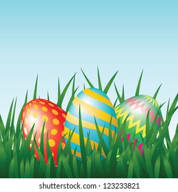 Greeting card with easter eggs on meadow