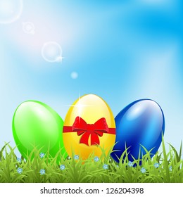 Greeting card with easter eggs on meadow