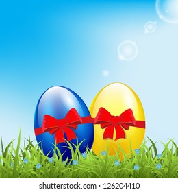 Greeting card with easter eggs on meadow