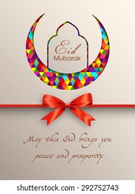 Greeting card of Eid Mubarak with intricate calligraphy and moon for the celebration of Muslim community festival.