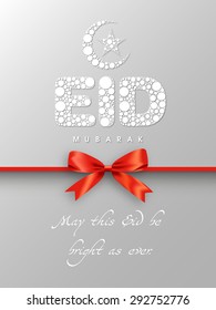 Greeting card of Eid Mubarak with intricate calligraphy and moon for the celebration of Muslim community festival.