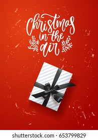  greeting card with gift box . Hand drawn calligraphy. concept handwritten Christmas in the air