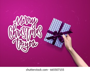 greeting card with giftbox . Hand drawn calligraphy. concept handwritten merry christmas to you
