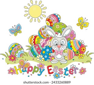 Greeting card with a happy Easter bunny and a pile of colorfully painted gift eggs on a pretty sunny lawn with spring flowers and merry butterflies fluttering around, vector cartoon illustration