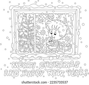 Greeting card with a little boy and his kitten sitting on a windowsill among holiday gifts and sweets and watching merry swirling snowflakes outside a window on a snowy Christmas night
