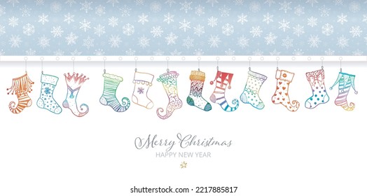 Greeting card with snowflakes on blue background and hanging doodle christmas stockings. Vector doodle illustration.