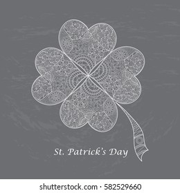 Greeting card for St. Patrick's Day with shamrock. Hand draw doodle clover with four leaves on coating board. Vector illustration.