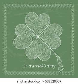 Greeting card for St. Patrick's Day with shamrock in a frame. Hand draw doodle clover with four leaves on green coating board. Vector illustration.