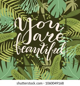 Greeting card You Are Beautiful with tropical leaves on dark green background