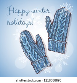 Greeting christmas card. Blue knitted mittens and snowflakes on a blue background